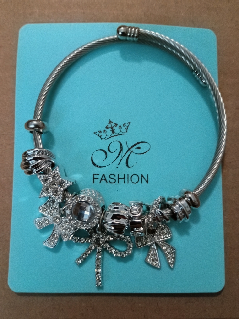 MNM Fashion Silver-Tone Charm Bracelet with Sparkling Bows